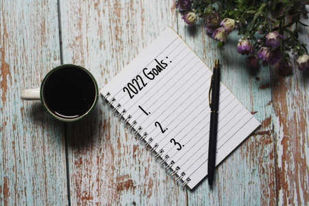 White notebook for notes, pen, wooden blue background. Top view Copy space, 2022 Goals text concept.の写真素材