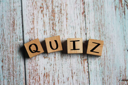 Word QUIZ. Wooden letters on blur wooden blur backgroundの写真素材