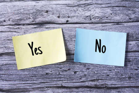 Yes and No wording on note. top view wooden tableの写真素材