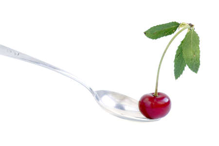 red cherry in silver spoon