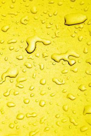 Golden droplets reflected in the waterの写真素材