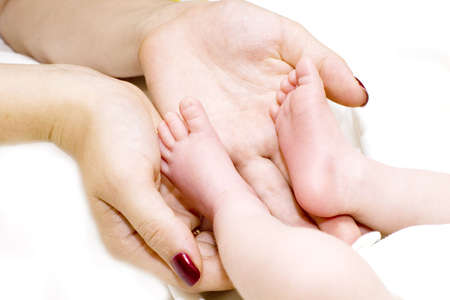 Mother holding her child's feet