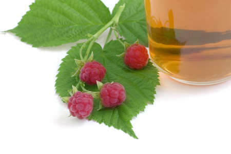 herbal tea in the cup with raspberry and green leaf