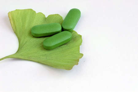 Closeup of Ginkgo Biloba and herbal pills の写真素材
