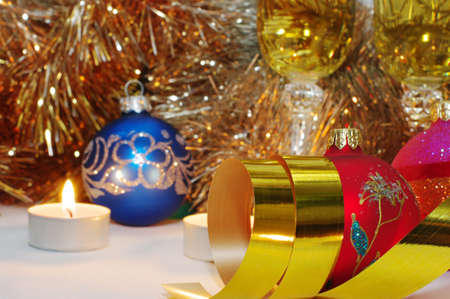 Two glasses of champagne lightening with candle in new year stuff with christmas balls

の写真素材