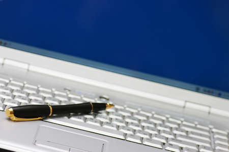 Business tools. Pen and keyboard of laptop.の写真素材