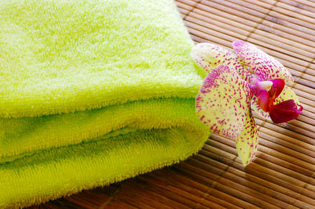 Spa concept of towel and orchid on bamboo matの写真素材