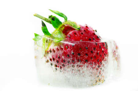 One strawberry ripe in the ice. Close-up strawberry into ice.の写真素材