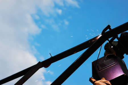 welding metal on the bleu background. Sky with clouds background.の写真素材