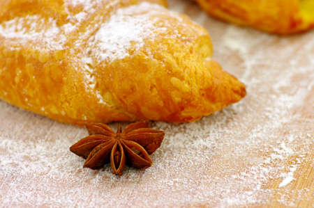 Some croissants on the wood texture with truestar spices. Focus on the truestar.の写真素材