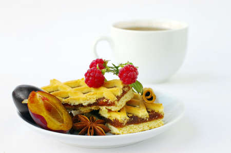 Hot tea and  cake with fruit. Focus on front of cake.の写真素材
