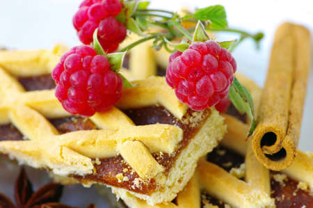 Plum cake with raspberry and stick of cinnamonの写真素材