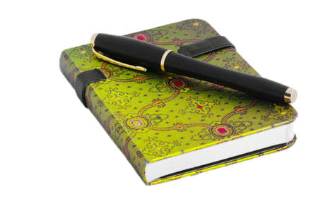 Notepad with arabic green ornament and pen on the white tableの写真素材