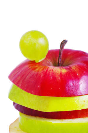 Apple slices made up of red and green on top of each otherの写真素材