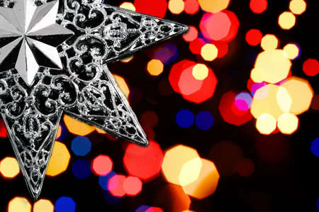 Decorative christmas star - on christmas lichts background..の写真素材