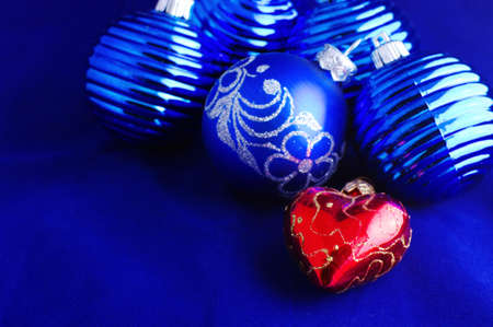 Blue Christmas baubles with silver decoration and one christmas ball look like heart の写真素材