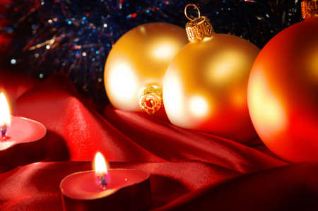 Christmas balls  with festive candles on the darkの写真素材