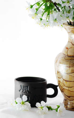 tea with cherry flowers over white backgroundの写真素材