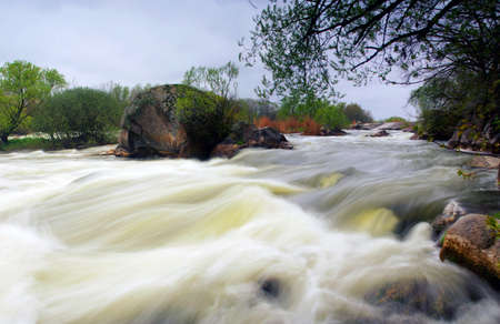 Threshold of the mountain river and wet stonesの写真素材