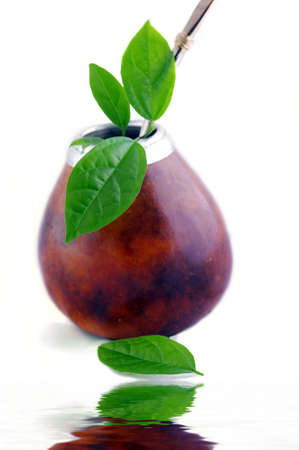 Isolated Leather Mate Cup with Straw and yerba green leafsの写真素材