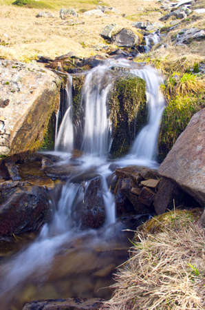 spring calm mountain landscape with river and snowの写真素材