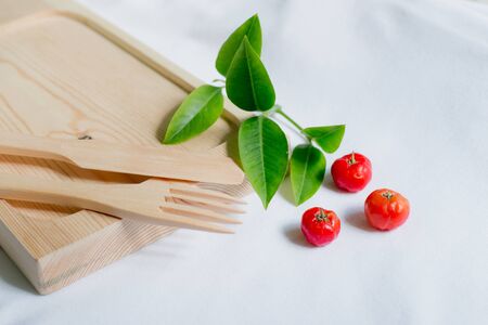 Wooden kitchenware with cheery and leaf decorationの写真素材