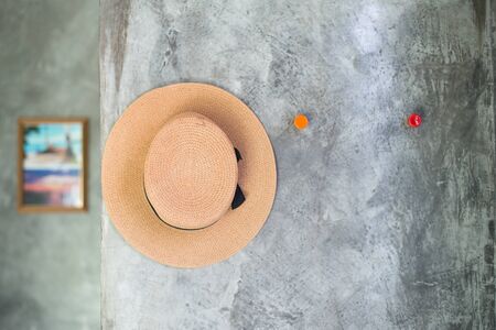 selective focus of hat hanging on the cement textured wall, imply to relax and vacationの写真素材
