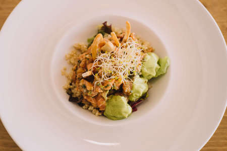 A creative version of salmon tartare with quinoa and avocadoの写真素材