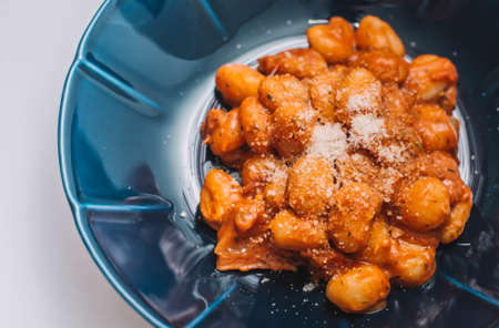 Plate of homemade gnocchi with tomato sauceの写真素材