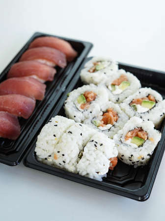 Tray with assorted pieces of sushi. California roll.