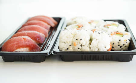 A tray with assorted pieces of sushi. California rolls.