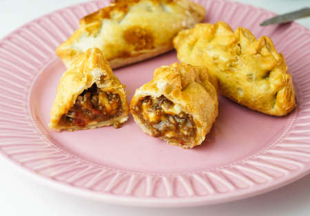 Several South American empanadas filled with meat and chickenの写真素材