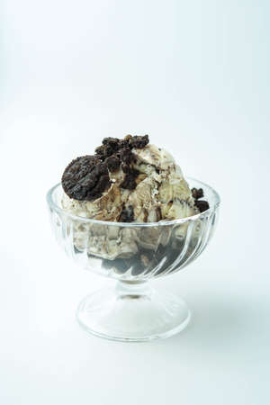 Cup of ice cream with pieces of chocolate chip cookie
