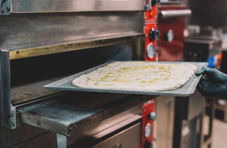 Preparation of a homemade Italian style pizza by a specialistの写真素材