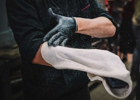 Preparation of a homemade Italian style pizza by a specialistの写真素材