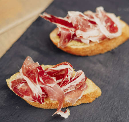 Two gourmet canapes of raw Iberian ham