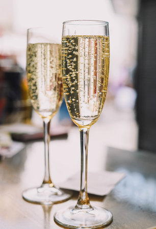 Two glasses of champagne on a table in a restaurant, close-up