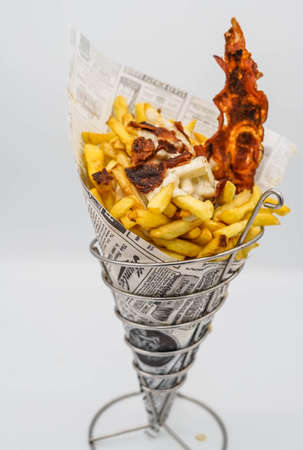 fries cone with ketchup and bacon ready to goの写真素材