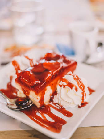 Slice of strawberry cake and creamの写真素材