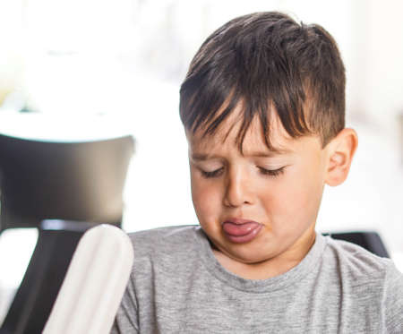 Caucasian boy enjoying a coconut lollyの写真素材
