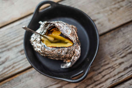 Grilled potato with butter and herbsの写真素材