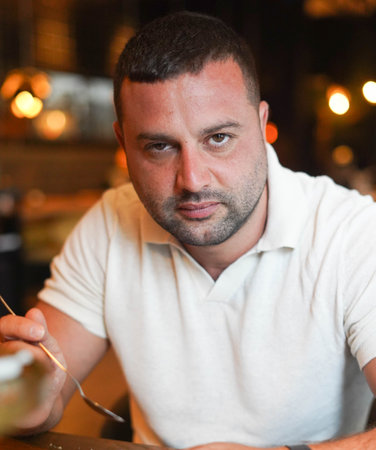 Middle aged man sitting in a bar having breakfast