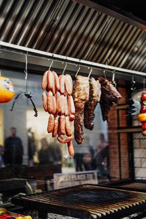 Meat and grill sausages hanging in a restaurantの写真素材