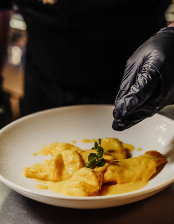 In this photo, we see a plate of homemade Italian pasta with a delicious sauce. The pasta is perfectly cooked and has a beautiful golden colour, with a slightly rough texture.の写真素材