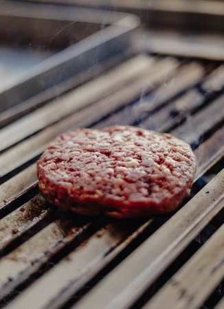 100% beef burgers on the griddle in a cafeteriaの写真素材