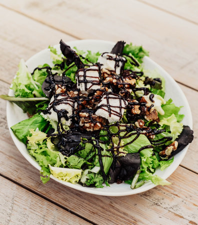 Gourmet plate of Caesar salad with chicken, parmesan, and crusty breadの写真素材