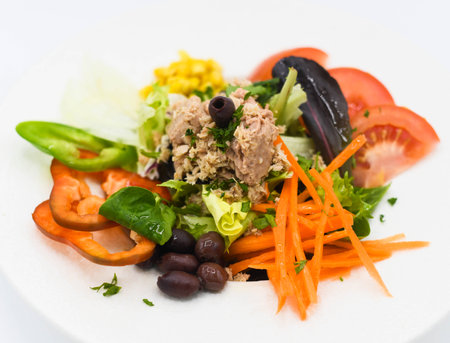 Tuna, tomato, carrot and black olives saladの写真素材