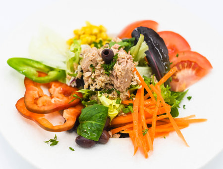 Tuna, tomato, carrot and black olives saladの写真素材