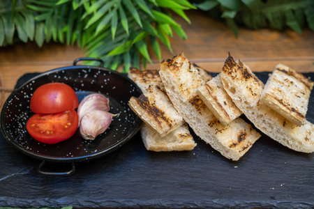 A typical serving of bread with tomato and garlic mayonnaise