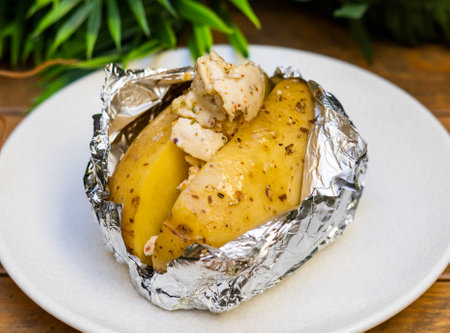 Potato roasted over fire with butterの写真素材